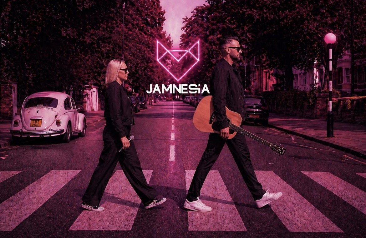 Vix Malone and DSHunt crossing a zebra crossing in pink light, with the neon Jamnesia fox logo above them